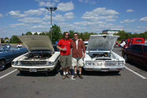 1970 Ford Mustang - Two men pose with their classic cars, a Dodge Charger and a Ford Falcon, at an outdoor car show.