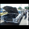 1970 Ford Mustang - 1970 Chevrolet Chevelle SS at a car show, hood open, revealing the engine bay.