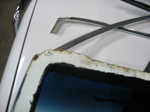1995 Ford C-350 (Centurion Conversions) - Windshield trim detail, likely from a vehicle, showing white and black components.
