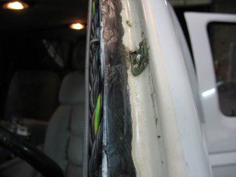 1995 Ford C-350 (Centurion Conversions) - Wiring harness detail inside a vehicle, showing a bundle of wires near the windshield frame.