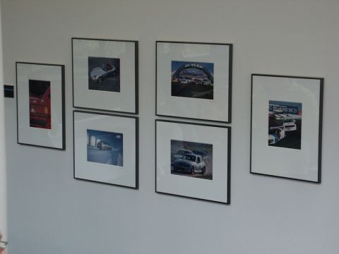 2001 Mercury Grand Marquis - A collection of framed car photographs are displayed on a wall, suggesting a passion for automotive imagery.