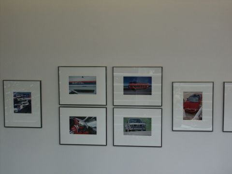 2001 Mercury Grand Marquis - Collection of framed automotive photographs mounted on a wall.