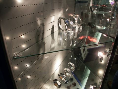 2001 Mercury Grand Marquis - A collection of watches are displayed on shelves within a glass display case.