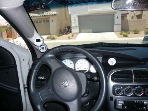 1996 Ford Probe - The interior of a Dodge Neon SRT-4 is visible, aftermarket gauges and a steering wheel with a Dodge emblem.