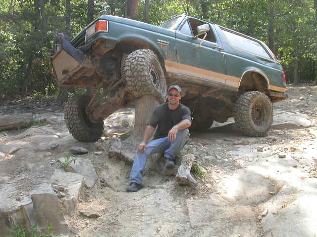 Green 1990 Ford Bronco on off-road trail