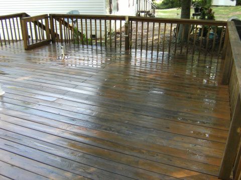 1992 Ford F-150 - A wet wooden deck with railings and stairs is visible, with water pooling on the planks.