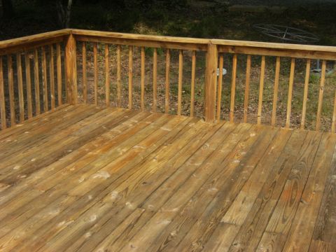 1992 Ford F-150 - Wooden deck with railing, background shows grass and a metal object.