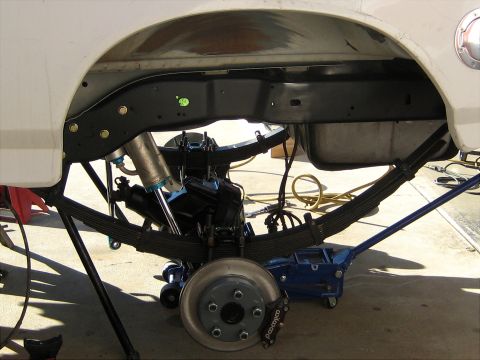 1996 Ford Bronco - Close-up of a vehicle's rear suspension system, showing leaf springs and shock absorbers.