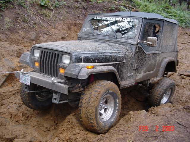 1995 Jeep Wrangler stuck in mud, front bumper has a license plate
