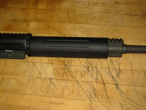 1996 Ford Bronco - Close-up view of a black rifle barrel and receiver assembly, showing the rail system on top.
