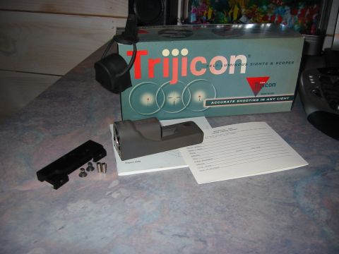 1996 Ford Bronco - A Trijicon self-luminous sight and scope box are displayed with a manual and mounting hardware.