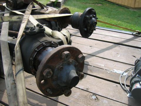 1992 Ford Mustang - A rear axle assembly, likely from a truck or heavy equipment, is secured with straps on a wooden trailer.