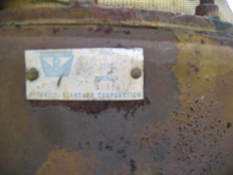 1992 Ford Mustang - Data plate on a rusty metal part, likely from industrial equipment.
