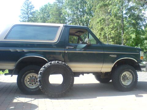 1985 Ford Bronco - This 1985 Ford Bronco is shown in a side profile with a spare tire placed beside it.