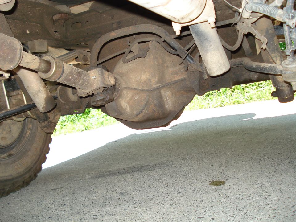 Underside view of a truck rear differential and leaf-spring suspension