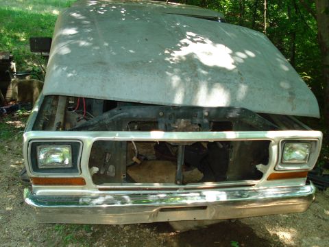 1989 Ford Bronco - The front end of a light-colored, older model truck with its hood open is shown. The grille and headlights are visible, and the vehicle app…