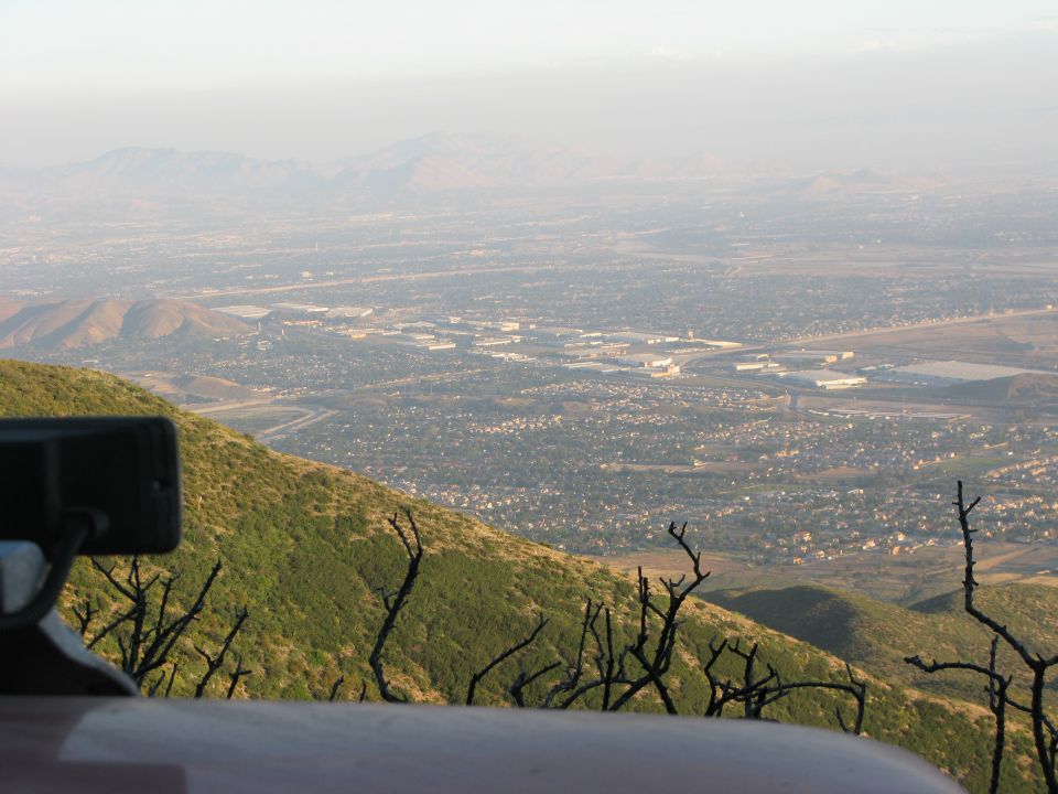 Elevated view of a town in a valley from a mountain trail