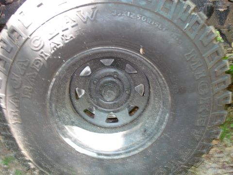 1989 Ford Bronco - A close-up view of a Mickey Thompson Baja Claw Radial tire on a vehicle wheel. The tire is labeled with "35X12.50R15LT".