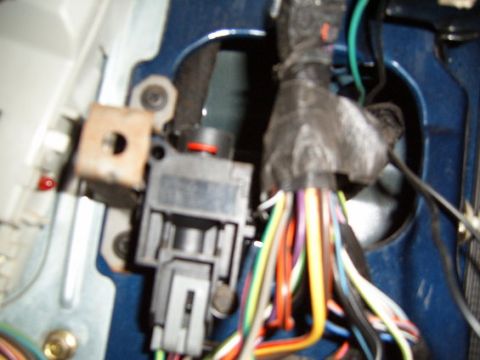 1991 Ford Bronco - A close-up view of a vehicle's wiring harness and ignition switch assembly, likely from a 1991 Ford Bronco. The image shows a black plastic…