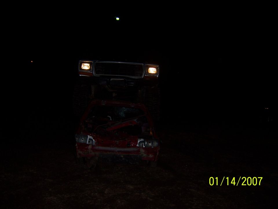 Truck with headlights on photographed at night under the moon