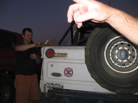 1996 Ford Bronco - Rear view of a 1996 Ford Bronco, a spare tire and various stickers on the tailgate.