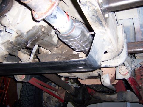 1991 Ford Bronco - Close-up view of the undercarriage, focusing on the exhaust and drivetrain components.