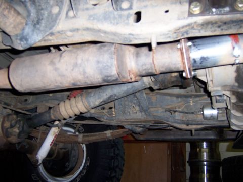 1991 Ford Bronco - Undercarriage view of a vehicle's exhaust system and suspension components.
