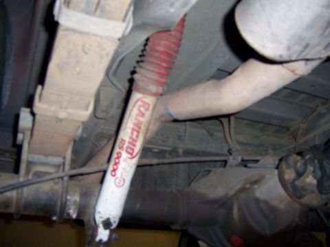 1991 Ford Bronco - Undercarriage view shows a Rancho RS 9000 shock absorber and leaf spring assembly.