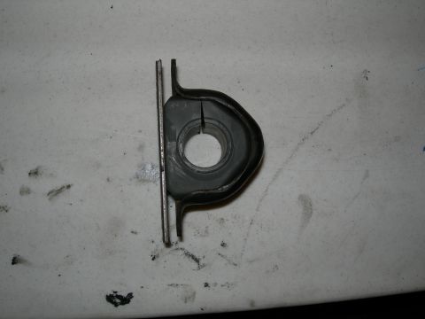 1992 Ford Taurus - A suspension bushing and its metal bracket are shown against a textured white background.