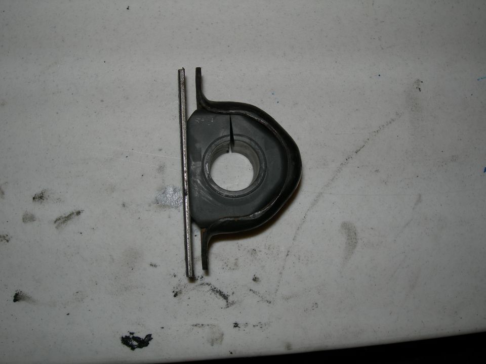 Suspension bushing with metal bracket on a white surface