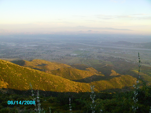 Hills and valley under a hazy sky, with a date stamp of 06/14/2008 and Supermotors logo