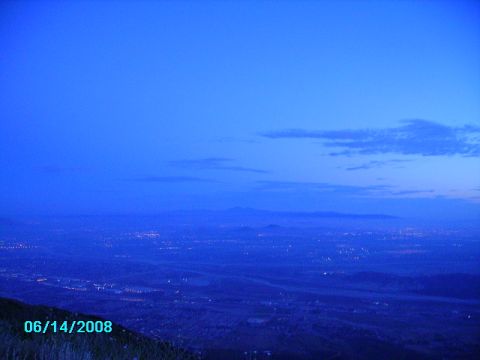 1990 Ford Bronco - A vast expanse of a city glows with lights under a deep blue twilight sky, captured on June 14, 2008.