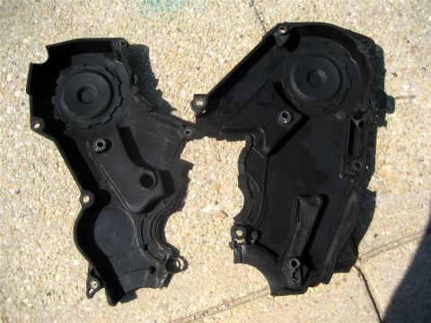1993 Ford Probe - This is a broken black plastic engine timing cover, likely from a vehicle.