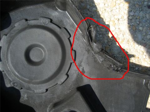 1993 Ford Probe - A damaged black plastic car part shows melted and torn material, indicating a significant issue.