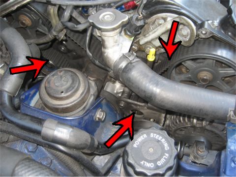 1993 Ford Probe - Close-up view of an engine bay, highlighting the timing belt system and power steering fluid reservoir cap.