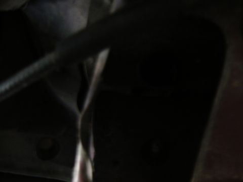 1988 Ford Bronco - This image shows a close-up view of the underside of a vehicle, focusing on frame and suspension parts.