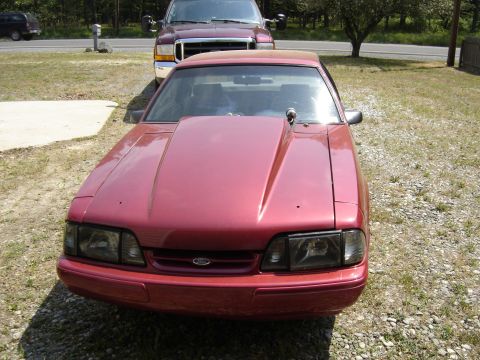 1988 Ford Bronco - This red coupe, identified as a 1988 Ford Bronco in the registry, is shown from the front with an aftermarket hood scoop.
