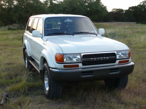 1986 Ford Bronco - This 1993 Toyota Land Cruiser is shown in a three-quarter front view in an outdoor setting.