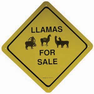 1990 Ford Bronco - A yellow diamond-shaped sign with black lettering reads "LLAMAS FOR SALE" and includes graphics of llamas.