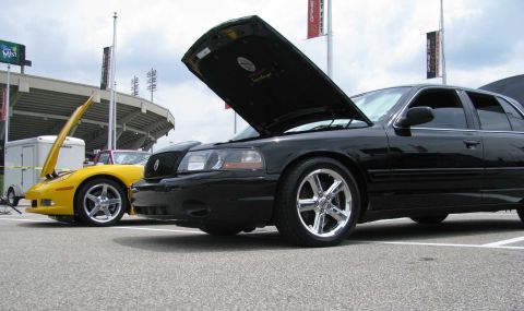 2003 Mercury Marauder - Two cars, a black sedan and a yellow sports car, are parked with their hoods open at an outdoor event.