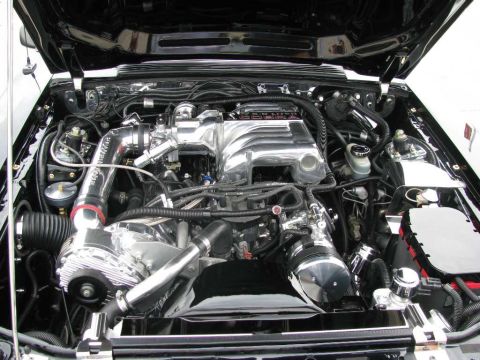 2003 Mercury Marauder - The engine bay features a polished supercharger and intake manifold, with visible hoses and wiring.