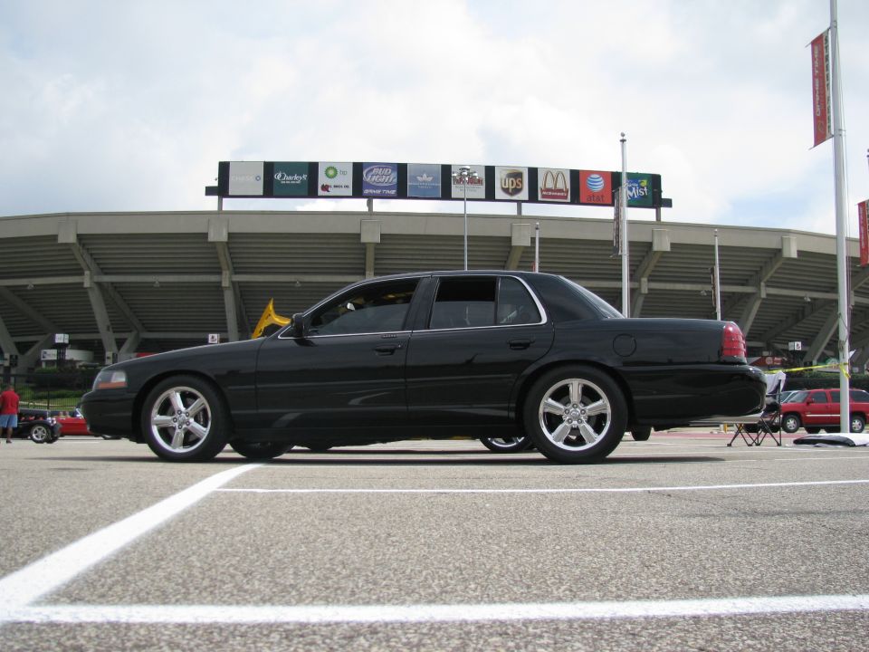 Black 2003 Mercury Marauder parked on asphalt with stadium in background