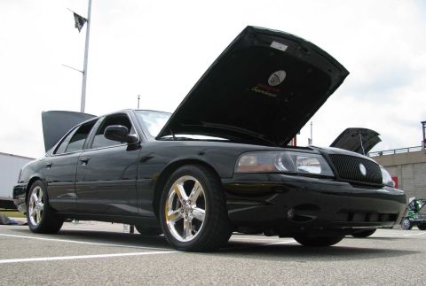 2003 Mercury Marauder - A black 2003 Mercury Marauder is shown with both hoods open, parked on pavement.