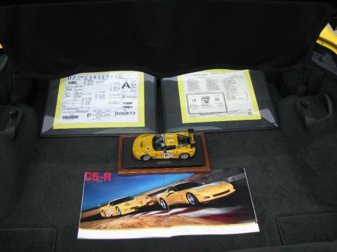 2003 Mercury Marauder - A model 2007 Corvette C5-R sits on display with window stickers in the trunk of a car.