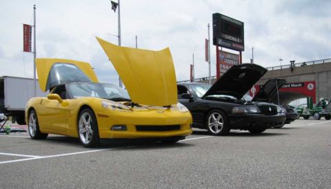 2003 Mercury Marauder - A black 2003 Mercury Marauder is parked with its hood open at a car show, alongside other vehicles.