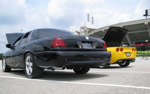 2003 Mercury Marauder - Two performance sedans, a Mercury Marauder and a Chevrolet Corvette, are parked side-by-side with their hoods open.