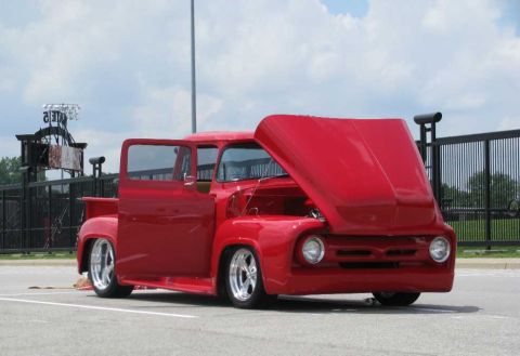 2003 Mercury Marauder - A bright red 1956 Ford F-100 pickup truck is shown with its hood and driver's door open.