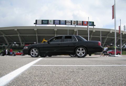 2003 Mercury Marauder - A black 2003 Mercury Marauder is seen from the side at a car show with a stadium in the background.