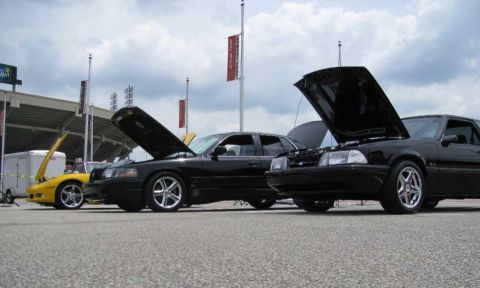 2003 Mercury Marauder - Three cars, including a 2003 Mercury Marauder, are parked with their hoods open at an outdoor event.