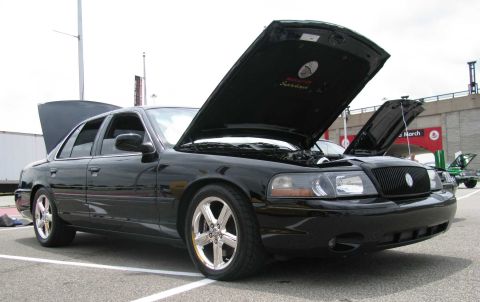 2003 Mercury Marauder - A black 2003 Mercury Marauder is parked with its hoods open, revealing the engine bay.